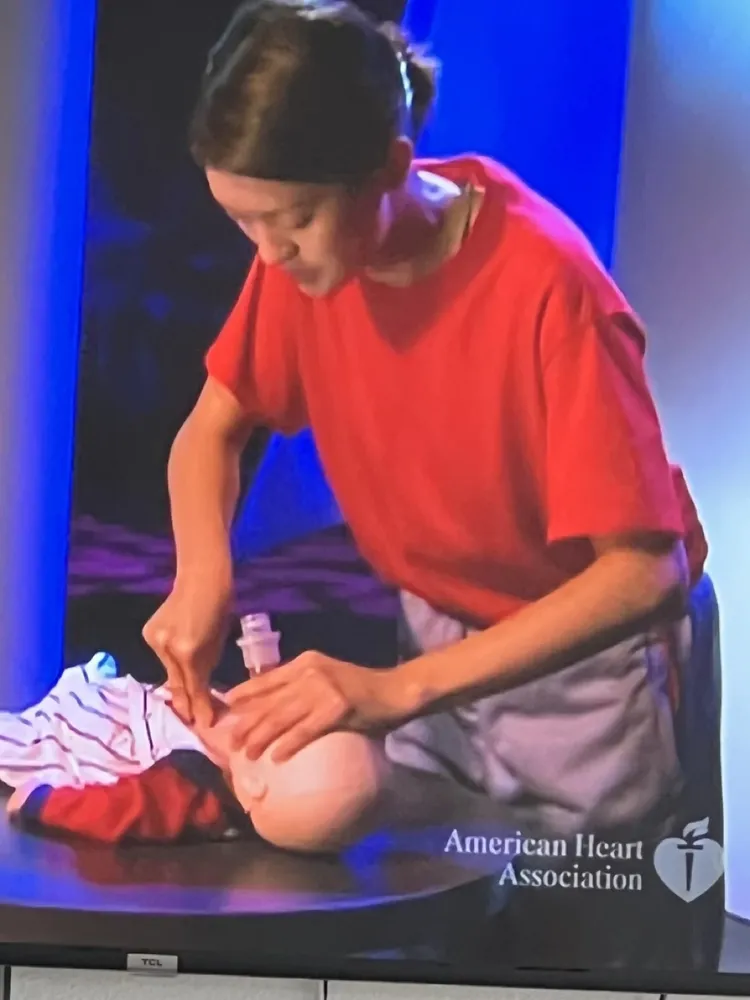Student practicing CPR on a training manikin