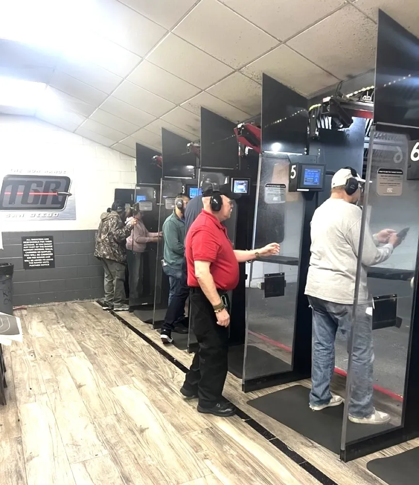 Instructor coaching students on an indoor shooting range